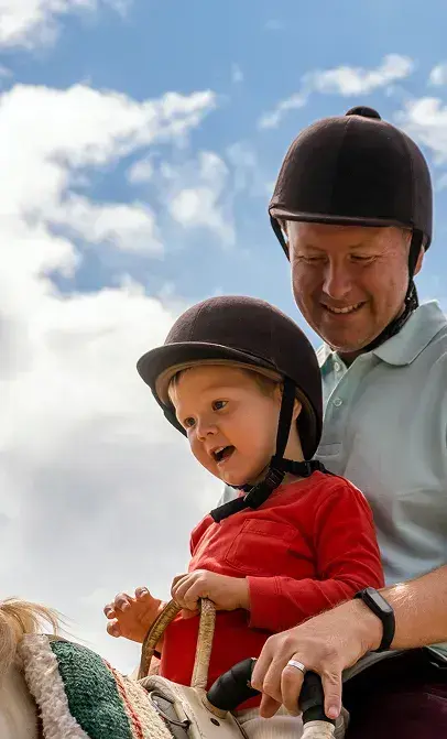 Parent and child on horseback